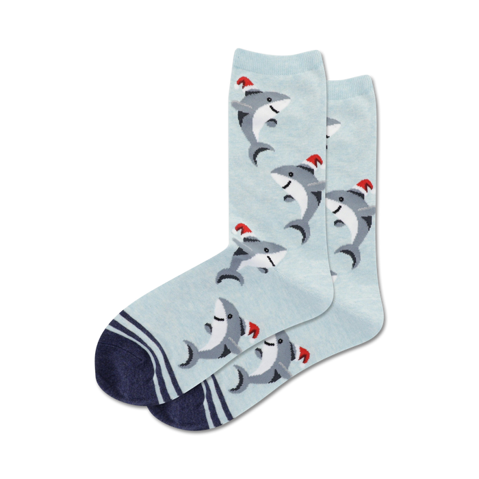 blue crew socks feature cartoon sharks wearing red santa hats, perfect for the holiday season.  