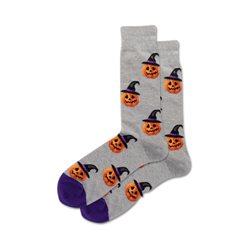gray crew socks with all-over pattern of cartoon pumpkin heads wearing witch hats; perfect for halloween fun.  