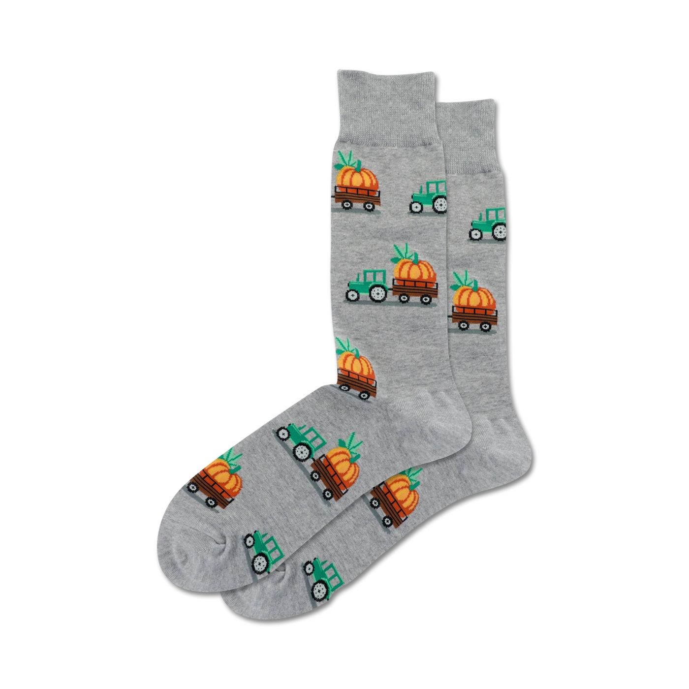 Pair of grey crew socks with a repeating pattern of green tractors carrying pumpkins. Festive fall design.