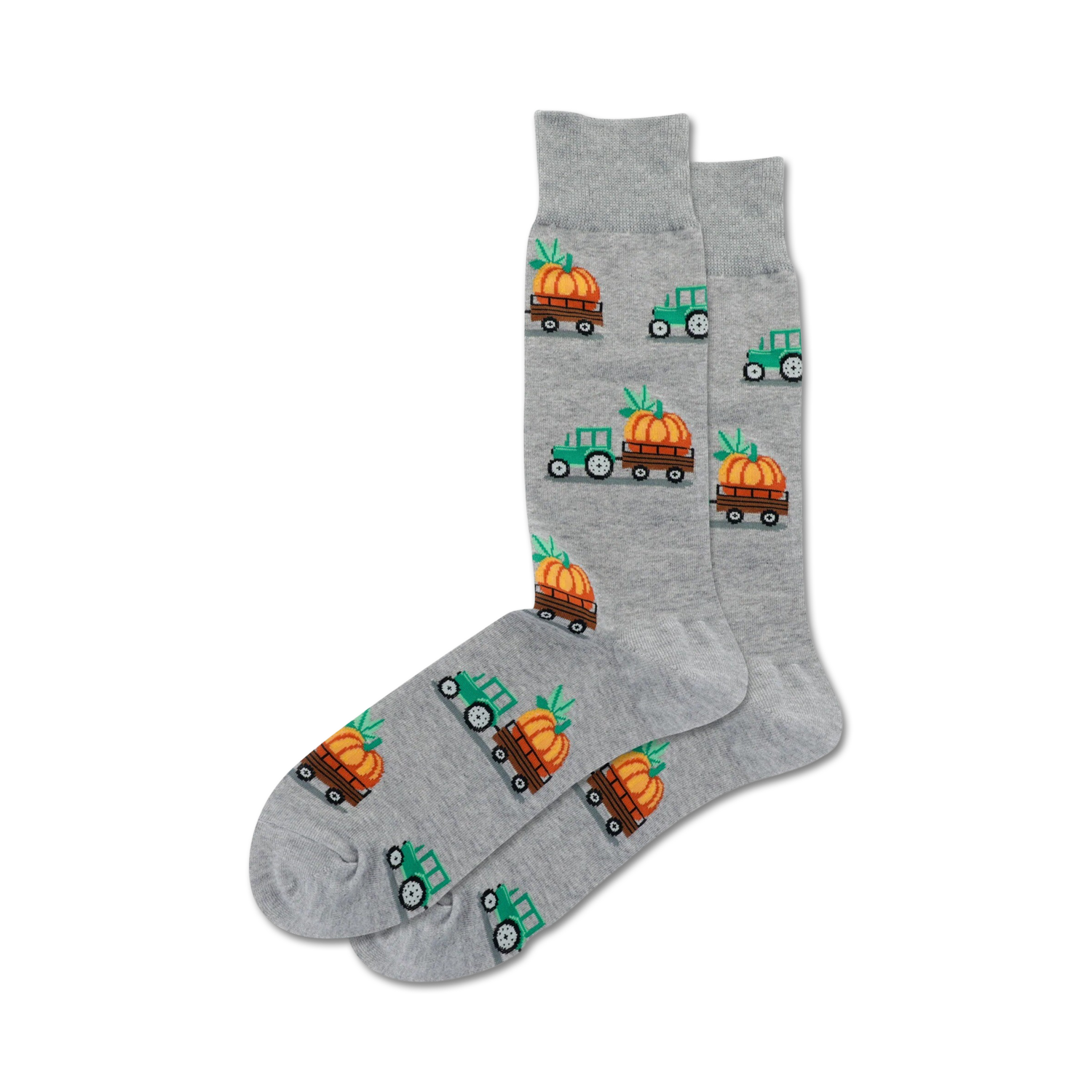 Pair of grey crew socks with a repeating pattern of green tractors carrying pumpkins. Festive fall design.
