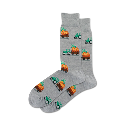 gray crew socks feature halloween pattern of green tractors with orange pumpkins in wooden wagons.  