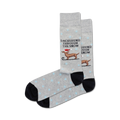 Pair of grey crew socks with a black cuff. Features a dachshund in a Santa hat sledding, snowflakes, and the text 'Dachshund Through the Snow'.