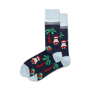 dark blue crew socks for men with an eye-catching pattern of santa clauses wearing red hats, sunglasses, and swimsuits. set against a background of palm trees and beach balls. the perfect gift for a quirky christmas lover.   