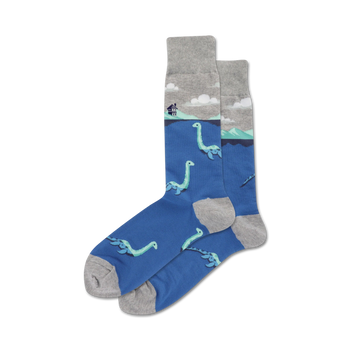 crew length men's socks with a plesiosaur pattern in a blue lake with a gray house and clouds.   