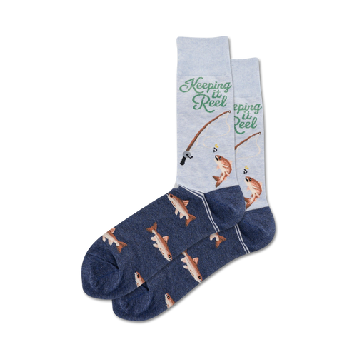 Pair of crew socks, navy blue and light grey, featuring a fishing-themed design with fish illustrations and the text 'Keeping it Reel'.