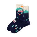 Pair of crew socks in navy blue with a cream and teal camper van design, mountains, and trees. 