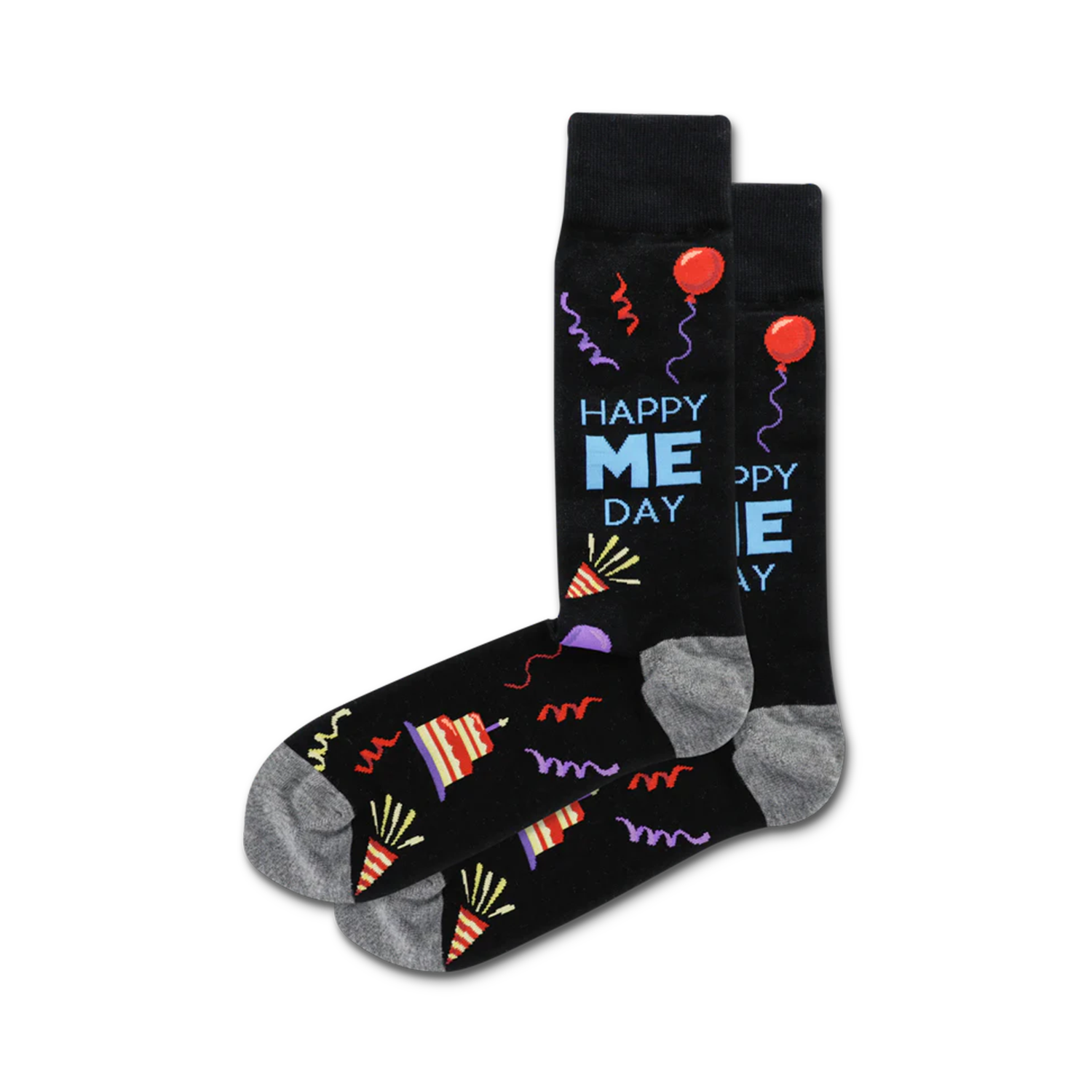 A pair of crew socks in black with a fun 'Happy Me Day' design, featuring colorful party hats, balloons, and streamers.