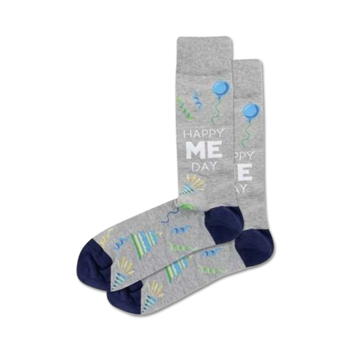 mens crew socks with gray body, blue toe and heel, party streamers, balloons, and words 'happy me day'.  