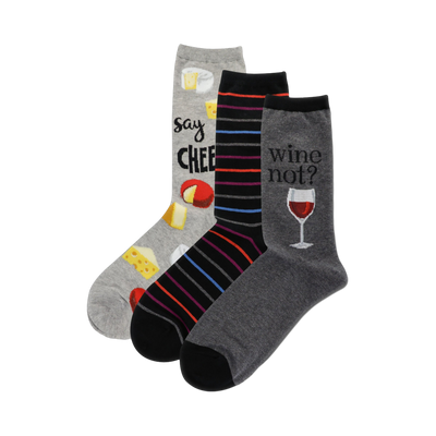 Three crew socks: one grey with cheese illustrations and 'Say Cheese', one black with colorful stripes, and one grey with a wine glass and 'Wine not?'