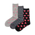 Three pairs of crew socks: gray with pink lightning bolts, gray with teal polka dots, and black with pink whole and broken hearts.