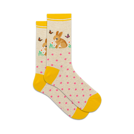 socks that are white with yellow stripes at the top and yellow toes and heels. there are pink polka dots all over the socks. there is a pattern of rabbits holding flowers in their paws and there are butterflies all around them.