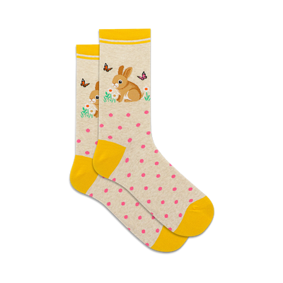 socks that are white with yellow stripes at the top and yellow toes and heels. there are pink polka dots all over the socks. there is a pattern of rabbits holding flowers in their paws and there are butterflies all around them.