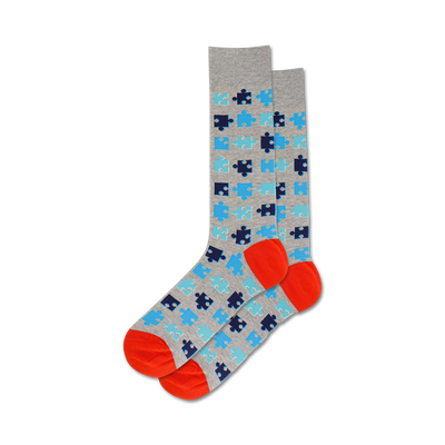 puzzle socks with light gray background, blue and orange puzzle pattern, orange toe and heel, crew length for men.   