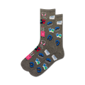 Pair of gray crew socks with colorful travel icons: suitcase, passport, headphones, sleep mask.  Perfect for wanderlusters!