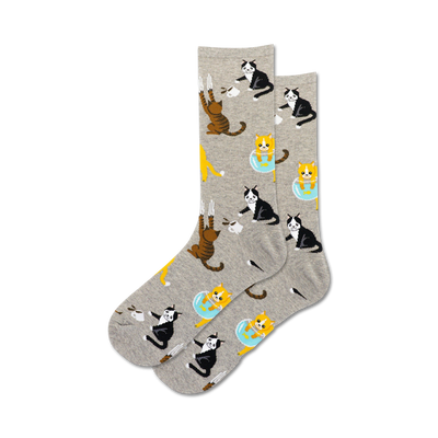 gray crew socks showcasing black, white, orange, and tabby cats doing mischevious things such as scratching, knocking over mugs, and reaching for fish in a bowl