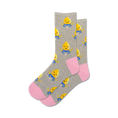 gray crew socks feature a pattern of yellow lemons with blue eyes meditating in a lotus position, promoting a sense of calm and serenity.   