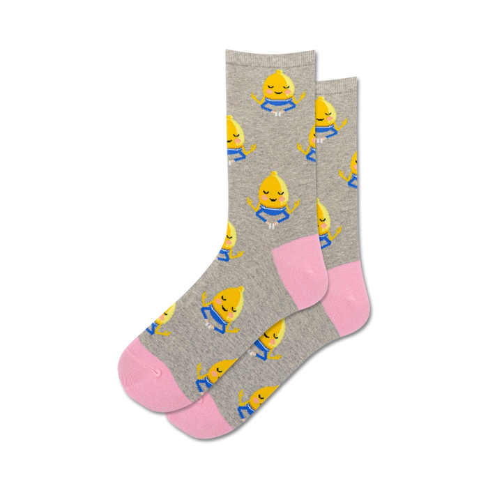gray crew socks feature a pattern of yellow lemons with blue eyes meditating in a lotus position, promoting a sense of calm and serenity.   