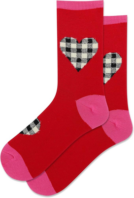 Pair of red crew socks with pink cuffs, heels, and toes. Large black and white fuzzy plaid heart on calf. Smaller plaid heart on foot.