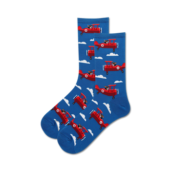 blue women's crew sock with white puffy cloud background and playful dog flying propeller plane.  