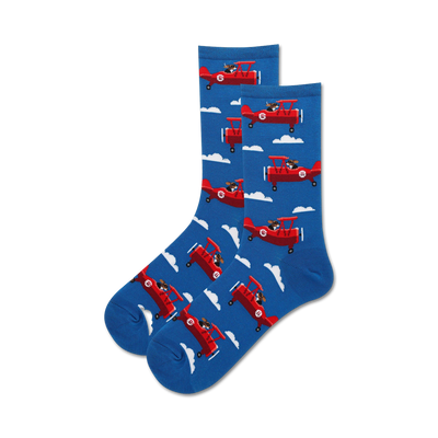 blue women's crew sock with white puffy cloud background and playful dog flying propeller plane.  