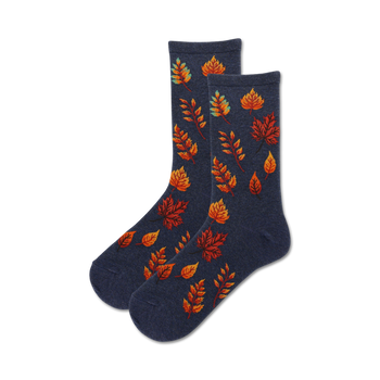 autumn leaves crew socks for women. pattern of fall leaves in orange, red, yellow, and teal on a navy blue background.  