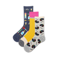 Three crew socks in a 3-pack. One navy blue sock features art supplies, one yellow sock has pencils, and one grey sock has paint palettes and brushes.