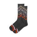Pair of charcoal gray crew socks with a geometric ombre pattern in orange and pink. The design features a subtle gradient effect.