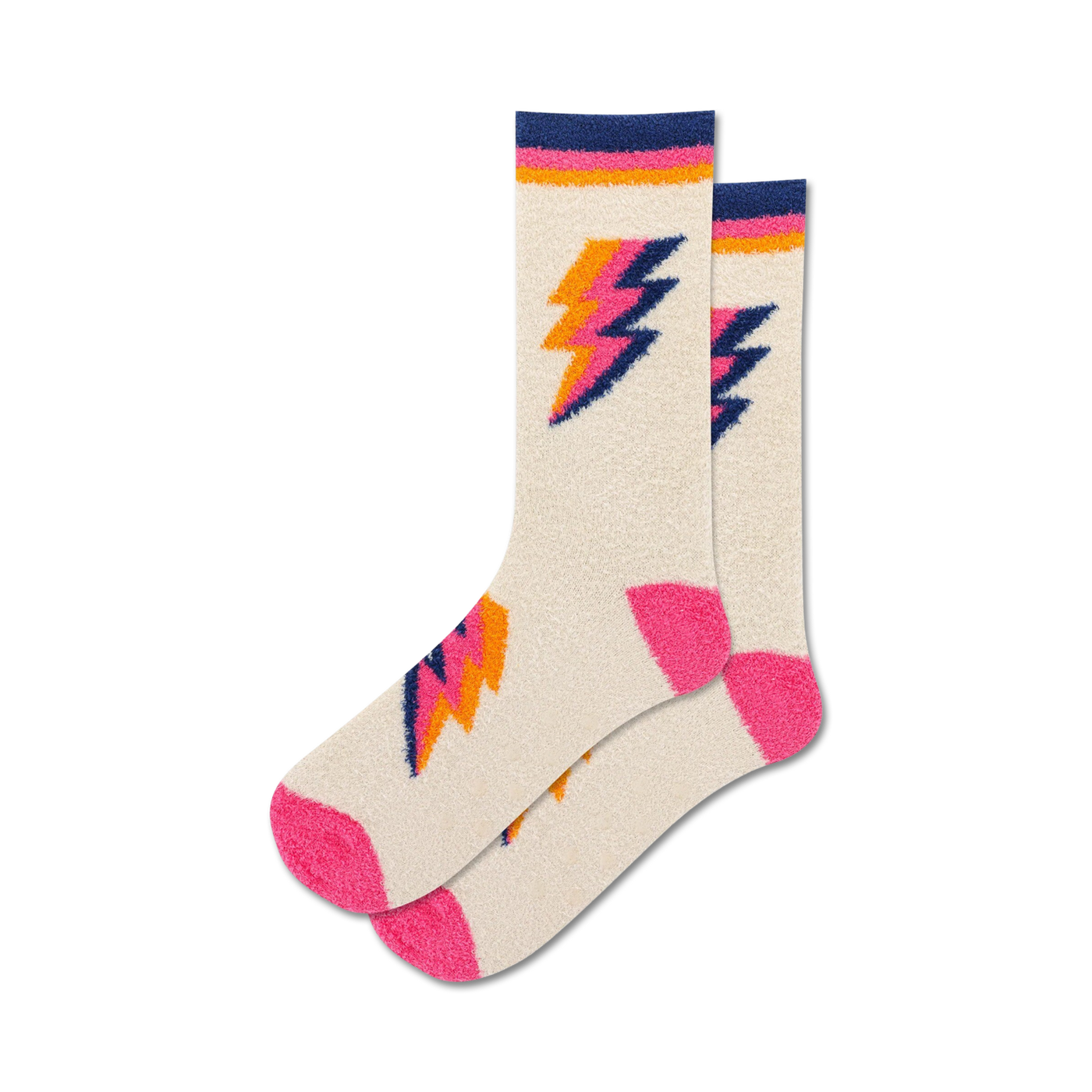 Pair of cream fuzzy crew socks with pink and orange lightning bolt designs. Non-skid grips on the sole.
