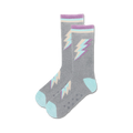 Lifestyle shot of gray fuzzy crew socks with pastel purple and teal lightning bolt designs. Non-skid grips on soles are visible.