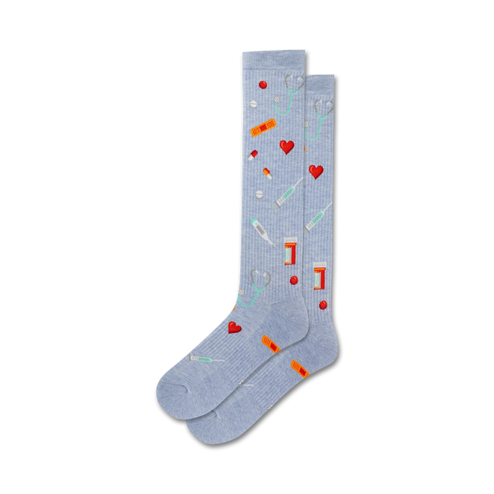 light blue womens crew socks with pattern of medical icons: hearts, pills, thermometers, stethoscopes, bandages.   }}
