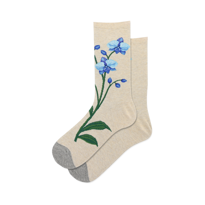 Pair of women's crew socks in beige featuring embroidered blue orchids. Grey heel and toe.