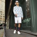 A full-body lifestyle shot of a man wearing a floral shirt and the navy blue poppy-print crew socks. The socks are partially visible. [lf]
