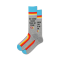 A pair of grey crew socks with rainbow stripes along the bottom and text that says, "Do these socks make me look gay?"