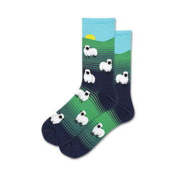 white sheep pattern on green and blue background. women's crew socks with dark blue toes and light blue tops.  