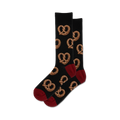 Pair of crew socks with a dark background and a repeating pattern of brown pretzels.  The socks have a burgundy-red toe and heel.