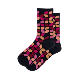 women's leafy geo crew socks feature geometric leaf shapes in pink, orange, red, and yellow on a black background.  