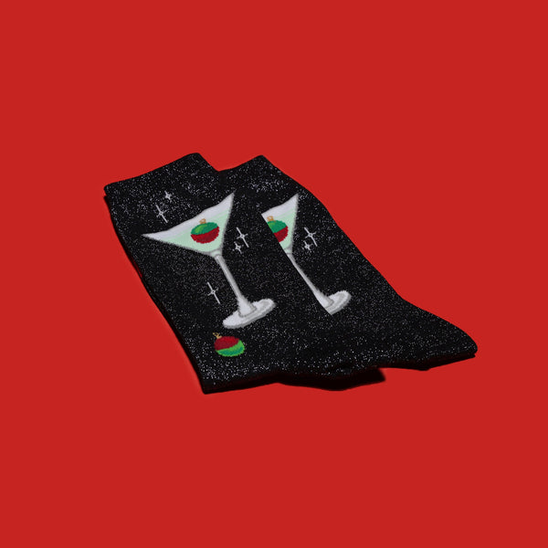 Flatlay product shot of Metallic Martini socks on a red background.  Shows the socks' design and texture. [lf]