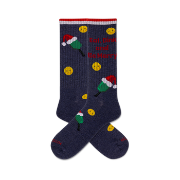 pair of blue crew socks with pickleball paddles wearing santa hats and the phrase "eat, dink and be merry."