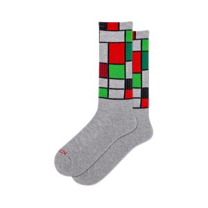 front view of two mondrian active socks with red, green, white, and black geometric patterns.