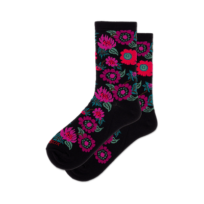 front view of black crew socks with pink and green floral pattern.