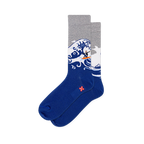 Crew socks with a solid dark blue foot, heather gray top, and a large crashing wave with a tiny surfer on an orange board.