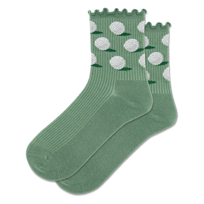 A pair of sage green crew socks with white dimpled golf balls and small green grass patches on the ankle, ribbed lower.