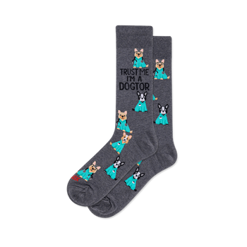 Dark grey crew socks with cartoon dogs in teal scrubs and stethoscopes. Text 'TRUST ME I'M A DOGTOR' on one sock.