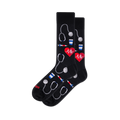 Black crew socks with a medical pattern of grey stethoscopes, red EKG hearts, colorful syringes, and blue and white cups.