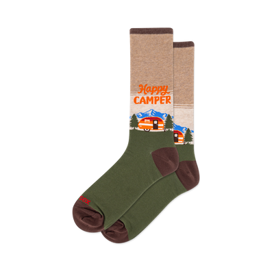 Crew socks with a tan upper, olive green lower, and brown accents. Design features "Happy Camper" text, orange camper, blue mountains, and green trees.