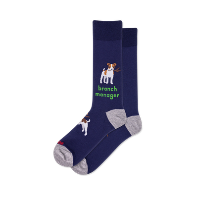 Pair of navy crew socks. One sock features a white and brown dog holding a stick with "branch manager" text in green. Grey heel and toe.