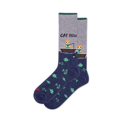 Crew socks with heather grey top, dark green cuff, and navy blue bottom. Design shows "CAT FISH" text, cats fishing from boats, and a pattern of green fish.