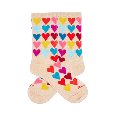 Two cream crew socks with a repeating pattern of colorful, fuzzy hearts in red, yellow, light blue, dark blue, magenta.