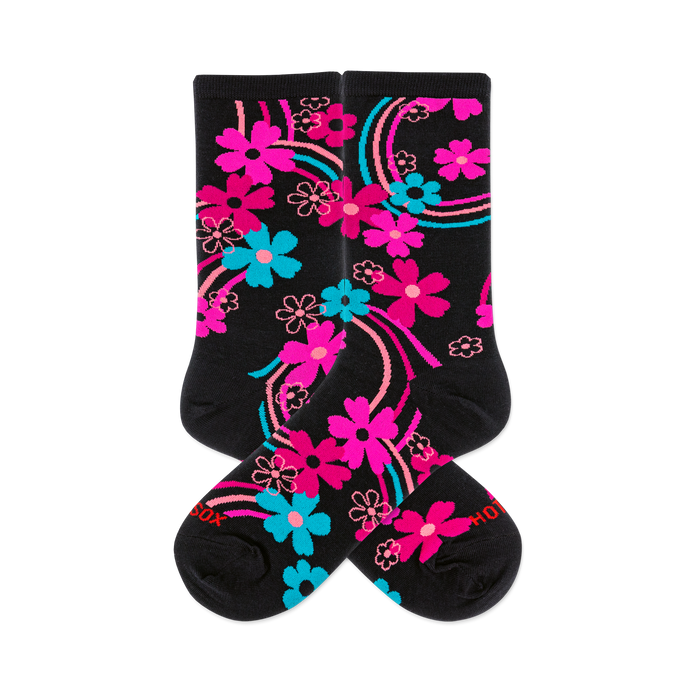 Pair of black crew socks with a vibrant rainbow floral pattern. Features hot pink, aqua, and outlined pink flowers and swirling lines. }}