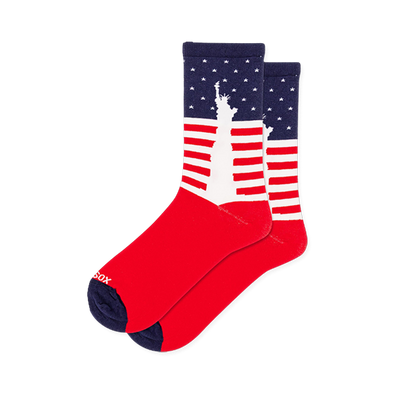 Patriotic crew socks featuring a white Statue of Liberty silhouette over a bold background of stars and stripes.